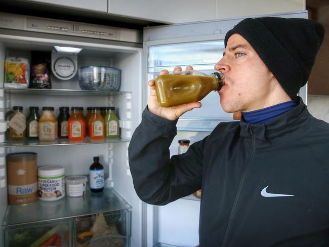 Cleansing: Nick Hall drinks one of the many juices he will have for the week. Picture: Colleen Petch