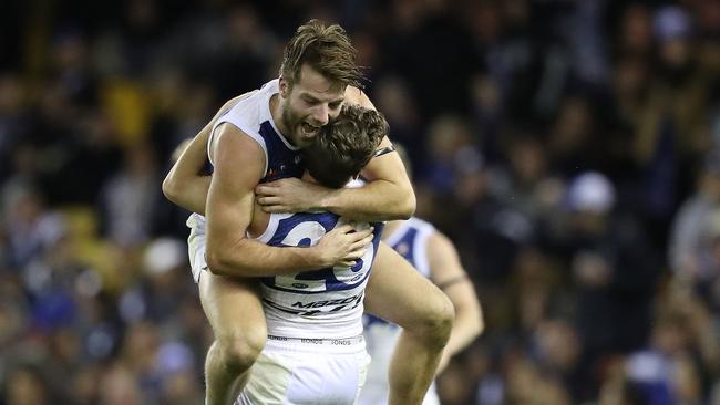 Luke McDonald jumps on teammate Kayne Turner after kicking a cruical last-quarter goal. Picture: Getty Images