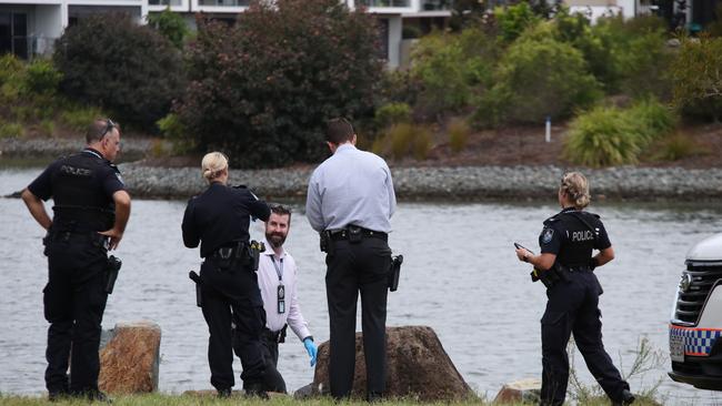 Police examine the scene after a body was found on the rocks at Emerald Lakes on the Gold Coast. Picture Glenn Hampson