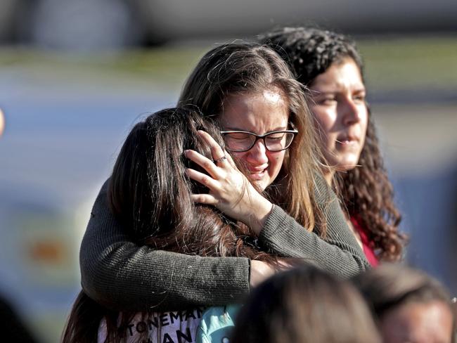 Students released from the lockdown embrace following the shooting. Picture: John McCall/South Florida Sun-Sentinel via AP