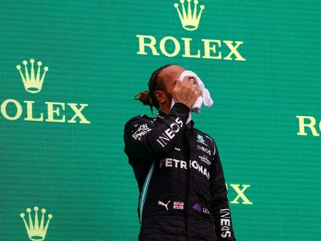 Lewis Hamilton wipes his face on the podium in Budapest. Picture: Getty Images