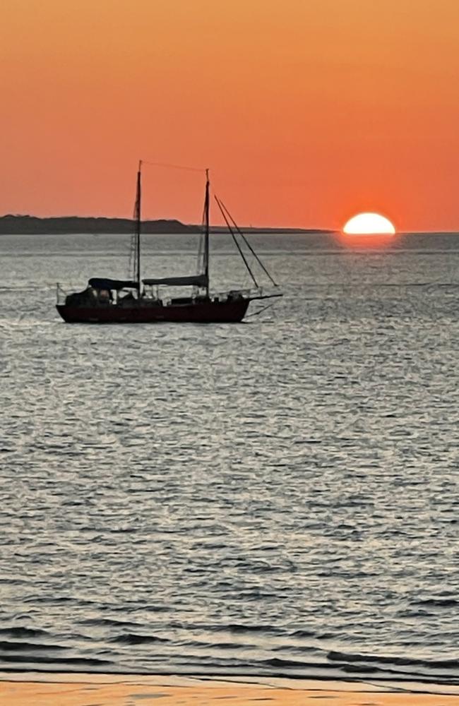 Sunset illuminates a lone sailboat in Cullen Bay. Picture: Colleen Thomson