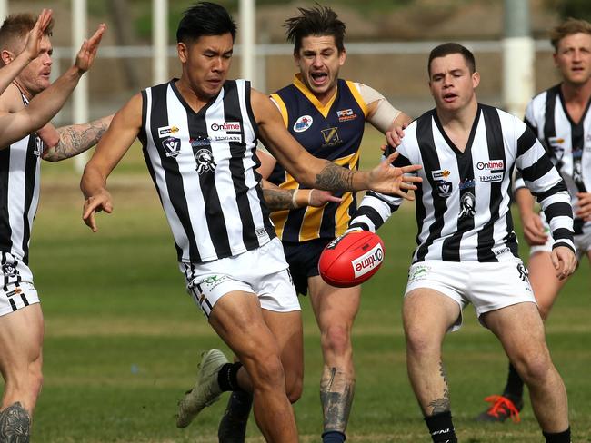 Wallan’s Michael Tang sends his team forward on Saturday. Picture: Hamish Blair