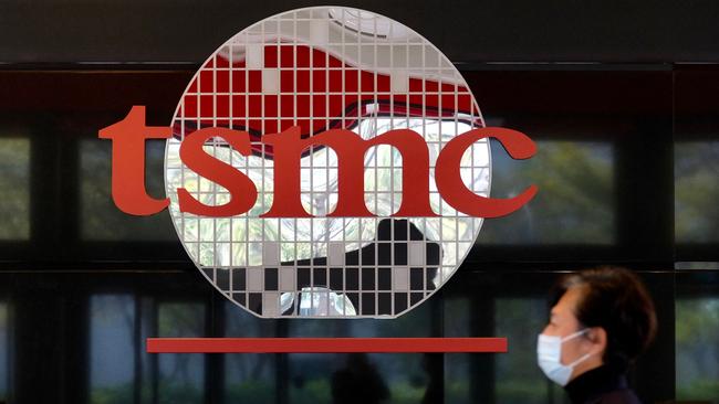 A man walking past the company logo of semiconductor maker Taiwan Semiconductor Manufacturing Company (TSMC) in Hsinchu. Establishing world-class domestic chip makers has become more pressing for China. Picture: AFP