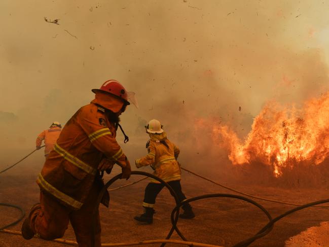 HILLVILLE, AUSTRALIA - NOVEMBER 13: RFS Firefighters battle a spot fire on November 13, 2019 in Hillville, Australia. Catastrophic fire conditions - the highest possible level of bushfire danger - have eased across greater Sydney, Illawarra and Hunter areas thanks to a slight cool change, however dozens of bushfires are still burning. A state of emergency, as declared by NSW Premier Gladys Berejiklian on Monday, is still in effect, giving emergency powers to Rural Fire Service Commissioner Shane Fitzsimmons and prohibiting fires across the state. (Photo by Sam Mooy/Getty Images)