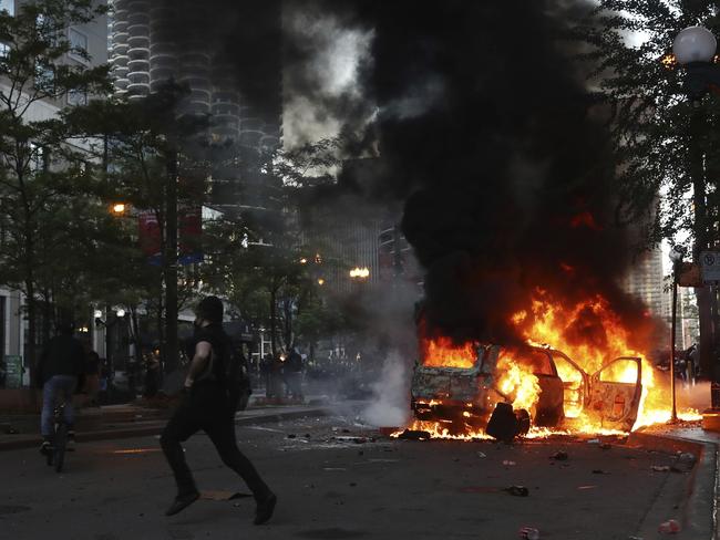 A car burns on North State Street, in Chicago. Picture: John J. Kim