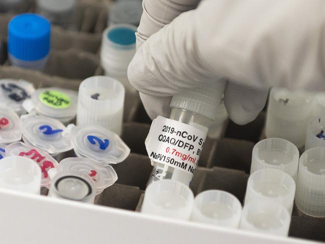 (FILES) In this file photo Dr. Nita Patel, Director of Antibody discovery and Vaccine development, lifts a vial with a potential coronavirus, Covid-19, vaccine at Novavax labs in Gaithersburg, Maryland on March 20, 2020, one of the labs developing a vaccine for the coronavirus, Covid-19. - As citizens across the world await a vaccine to end the coronavirus pandemic, a survey by Pew Research Center published on September 29, 2020 has good news: scientists and their research are widely viewed positively across much of the globe. The center polled 32,000 people between October 2019 to March 2020 in Europe, the Asia-Pacific region, and in the United States, Canada, Brazil and Russia, finding that a median of 82 percent consider government investment in scientific research worthwhile. (Photo by ANDREW CABALLERO-REYNOLDS / AFP)