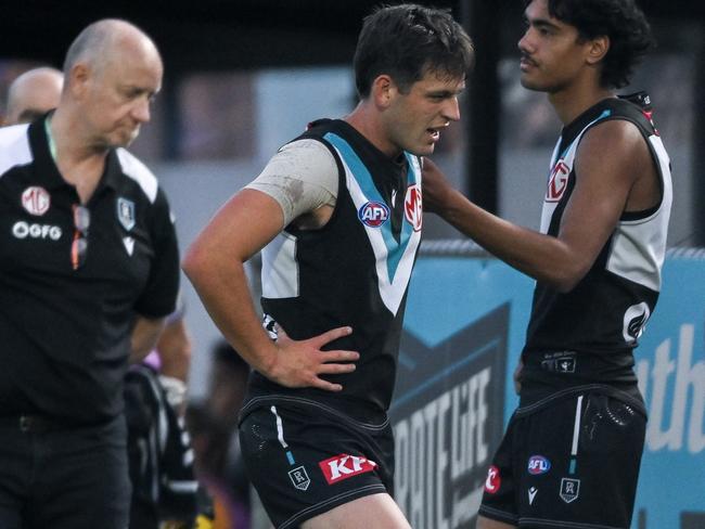 ADELAIDE, AUSTRALIA - MARCH 01:  Zak Butters of the Power   leave the ground after hurting his ankle during the 2024 AFL Community Series match between Port Adelaide Power and Fremantle Dockers at Alberton Oval on March 01, 2024 in Adelaide, Australia. (Photo by Mark Brake/Getty Images)