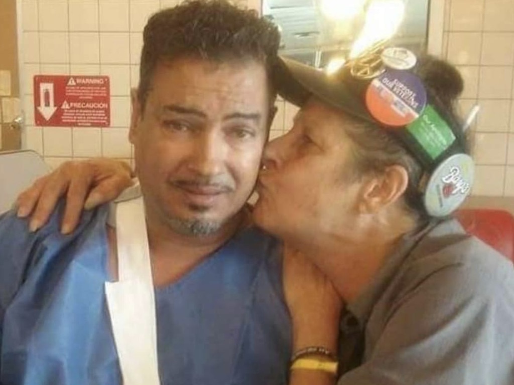 Orlando Torres with the picture taken off him in hospital scrubs at a fast food restaurant the morning after the massacre.