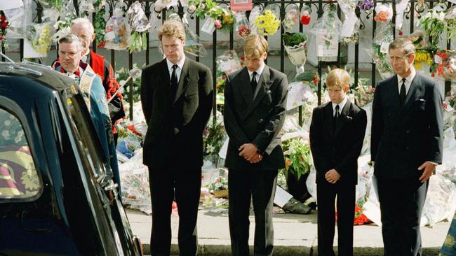 Prince Harry (second from right), then just 12, bows his head as the hearse carrying the body of his mother, Diana, passes by. He stands alongside (from left) his uncle Earl Charles Spencer, his brother Prince Williams and his father Prince Charles.