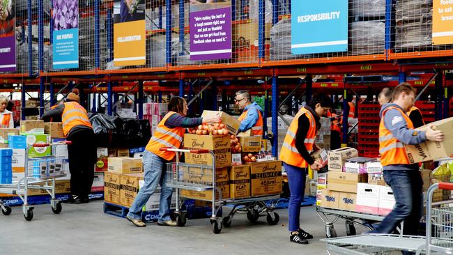 Foodbank’s enormous warehouse in western Sydney provides for 600 charities a week, a growing number of which are used by working families.