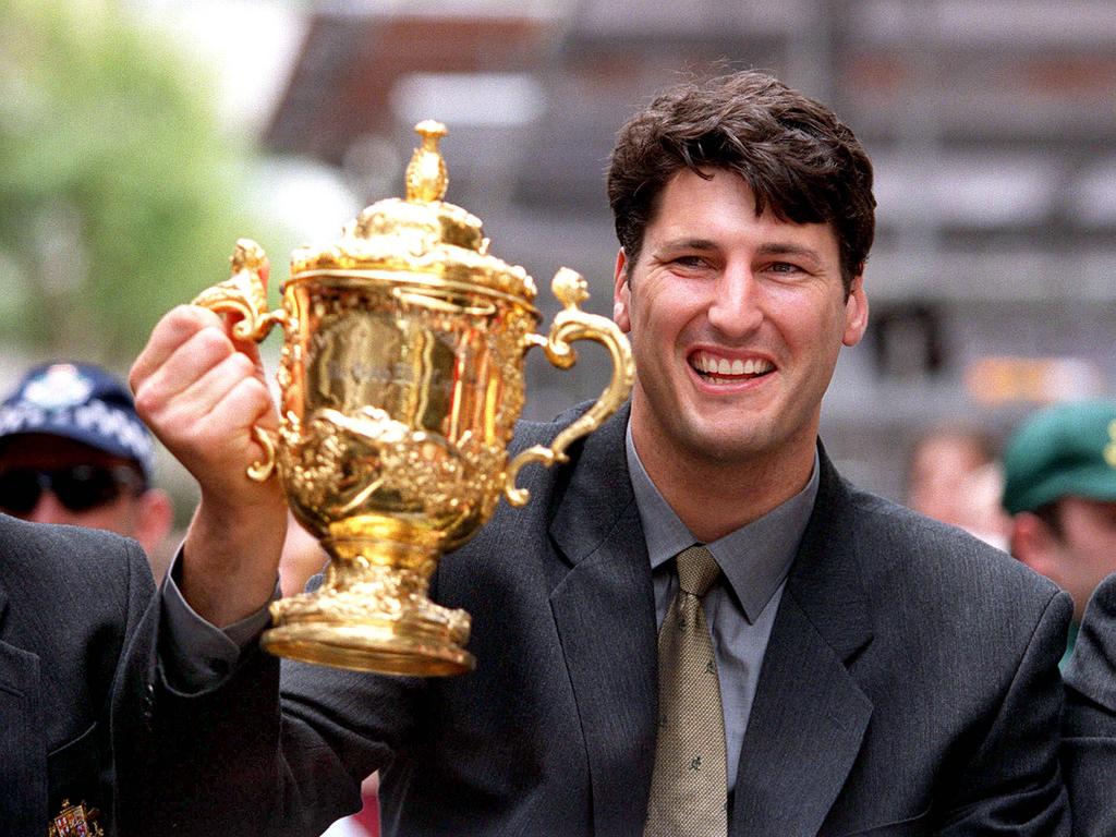 Wallabies captain John Eales with William (Bill) Webb Ellis World Cup trophy during ticker-tape parade in Queen Street Mall in Brisbane, 18/11/99. Pic Bruce Long.