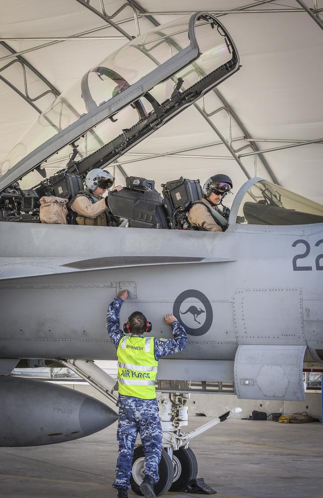 F/A-18F Super Hornet aircrew and aircraft technician make last minute preparations for a mission in the Middle East. Picture: Defence