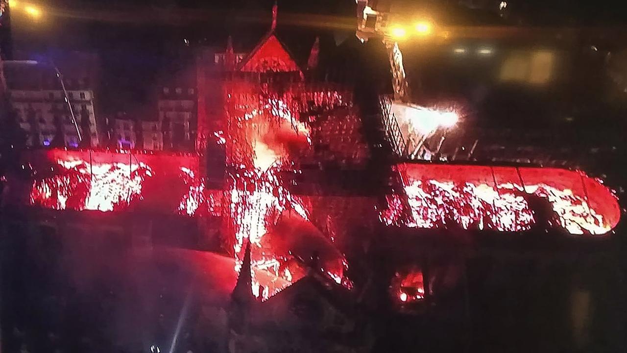 An image taken from a television screen shows an aerial view of the Notre-Dame Cathedral engulfed in flames. Picture: Stringer / AFP 