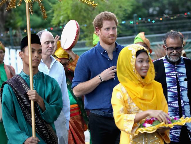 Prince Harry is welcomed by a procession of drummers playing the ‘kompang’, a traditional drum, during a visit to Jamiyah Children’s Home in Singapore