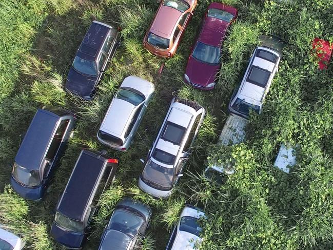 *ONE TIME WEB USE FOR NEWS.COM.AU* EXCLUSIVE. SPECIAL FEES APPLY . MANDATORY CREDIT: Arkadiusz Podniesinski/REX Shutterstock Mandatory Credit: Photo by Arkadiusz Podniesinski/REX Shutterstock (5224634a) An aerial photograph of abandoned vehicles. They can?t be removed until the owners give their consent. In the background the hills to which the schoolchildren escaped. Fukushima, Japan - Sep 2015 FULL COPY: http://www.rexfeatures.com/nanolink/r7ku MINIMUM USE FEE A photographer has taken stunning and revealing pictures of the exclusion zone from the 2011 Fukushima Nuclear Disaster. Within a 20km radius the radioactive exclusion zone demonstrates the dangerous nature of nuclear energy. A network of abandoned towns and villages that once housed hundreds of thousands of people, the exclusion zone of the largest nuclear accident since Chernobyl is eerie and frightening.