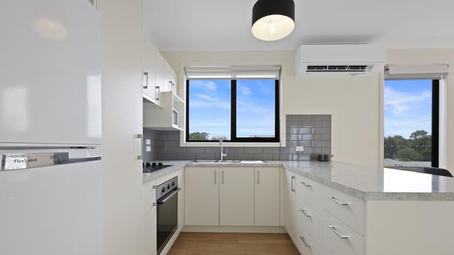 White cabinetry with stainless steel accents in the kitchen.