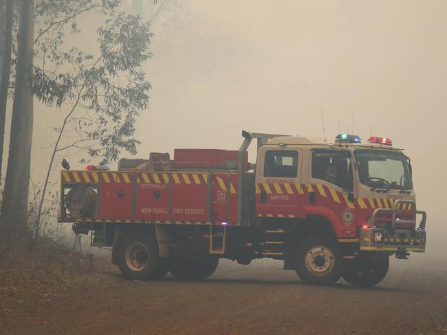 Firefighters battle bushfires in Busbys Flat, northern NSW, Wednesday, October 9, 2019. (AAP Image/Jason O'Brien)