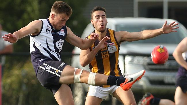 Melton Central’s Milan Savic kicks under pressure. Picture: Hamish Blair