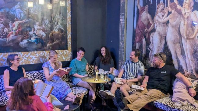 Lost in the pages: Silent Book Club members and venue coowner Briant Clark share a quiet moment of reading and reflection at The Last Supper Pizzarella. Picture: Taylor Mason.
