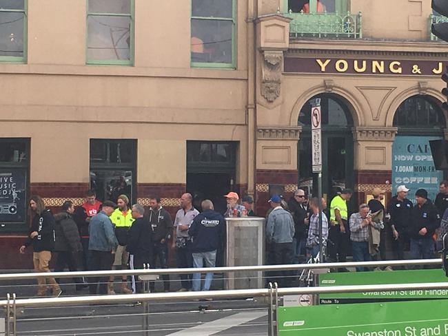 Union workers outside Young and Jacksons on Flinders St after the rally.<br/>                                             <a class="capi-image" capiId="aaec5c5ac366c0734020e8b5bd6b4e84"></a>