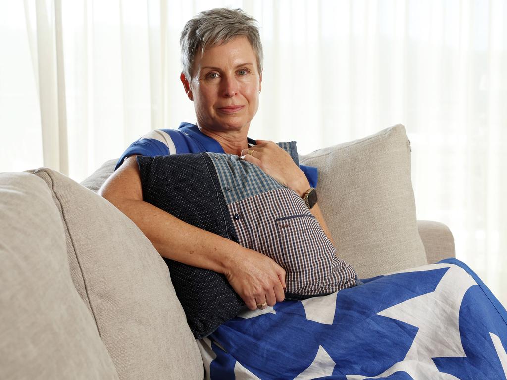 Pauline McGrath embraces a pillow made from her late husband’s shirts, after he died from voluntary assisted dying. Picture: Liam Kidston