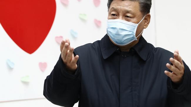 Chinese President Xi Jinping gestures near a heart shape sign and the slogan "Race against time, Fight the Virus" during an inspection of the centre for disease control and prevention of Chaoyang District in Beijing on Wednesday. Picture: Liu Bin/Xinhua via AP