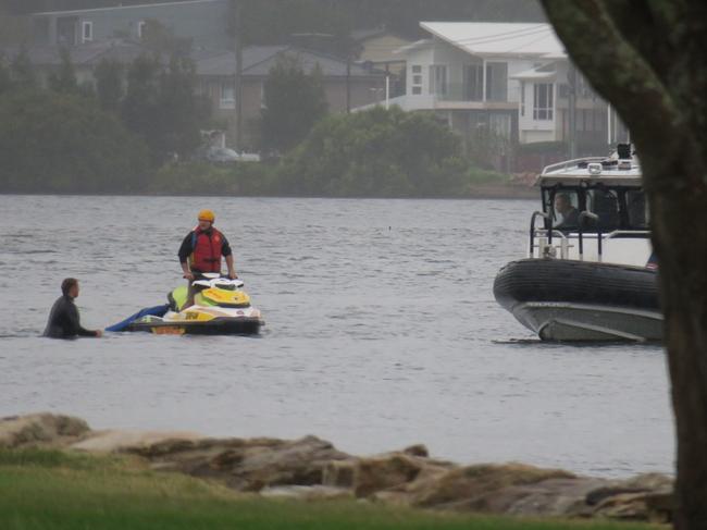 Emergency services responding to a car that has driven off a boat ramp at Lions Park in Woy Woy. Picture: Richard Noone