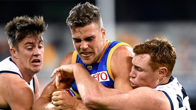 Adealide's Riley Knight and Tom Lynch wrap up Brisbane’s Tom Cutler on Saturday night. Picture: Bradley Kanaris/Getty Images