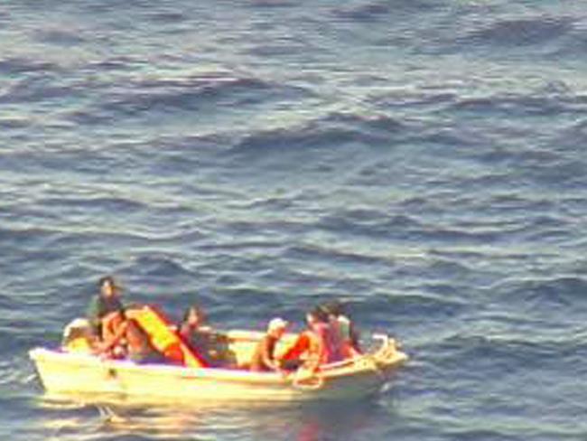 This video screengrab received from the New Zealand Defence Force (NZDF) on January 28, 2018 and taken from a Royal New Zealand Air Force P-3K2 Orion aircraft shows a five-metre dinghy adrift at sea in the Pacific Ocean with seven people on board, survivors from a ferry carrying 50 that was reported missing in Kiribati waters over a week ago. The Orion plane involved in the multinational search for the ferry MV Butiraoi dropped urgent supplies to the seven and a nearby fishing vessel has been diverted to rescue them. / AFP PHOTO / NEW ZEALAND DEFENCE FORCE / Handout / -----EDITORS NOTE --- RESTRICTED TO EDITORIAL USE - MANDATORY CREDIT "AFP PHOTO / New Zealand Defence Force" - NO MARKETING - NO ADVERTISING CAMPAIGNS - DISTRIBUTED AS A SERVICE TO CLIENTS