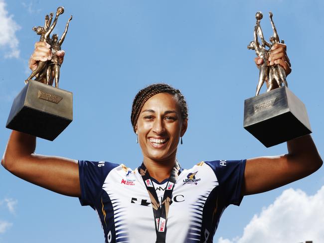 Lightning Captain and Goal Keeper Geva Mentor proudly holds aloft their back to back Super Netball Trophys. Photo Lachie Millard