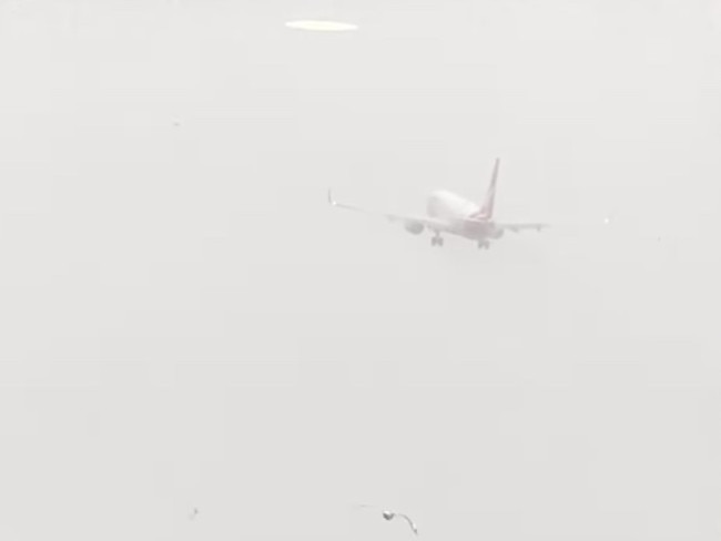 A Qantas plane aborts its landing at Hamilton Island after heavy rain.