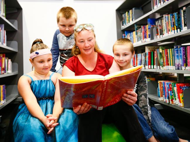 Launceston mother Carissa reads with her children, from left, Mia, 6, Noah, 10, and Bayden 11. Smith Family. Picture: Patrick Gee