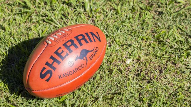 "Lismore, NSW, Australia - May 9, 2012: A Kangaroo Brand Sherrin football sits on grass. This is the official ball of AFL, Australian Rules Football, and has been used since the 1880s"