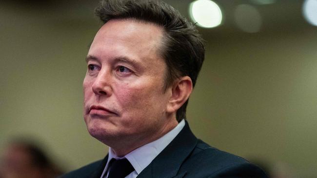 Elon Musk listens as US President-elect Donald Trump speaks during a meeting with House Republicans at the Hyatt Regency hotel in Washington, DC on November 13, 2024. (Photo by Allison ROBBERT / POOL / AFP)