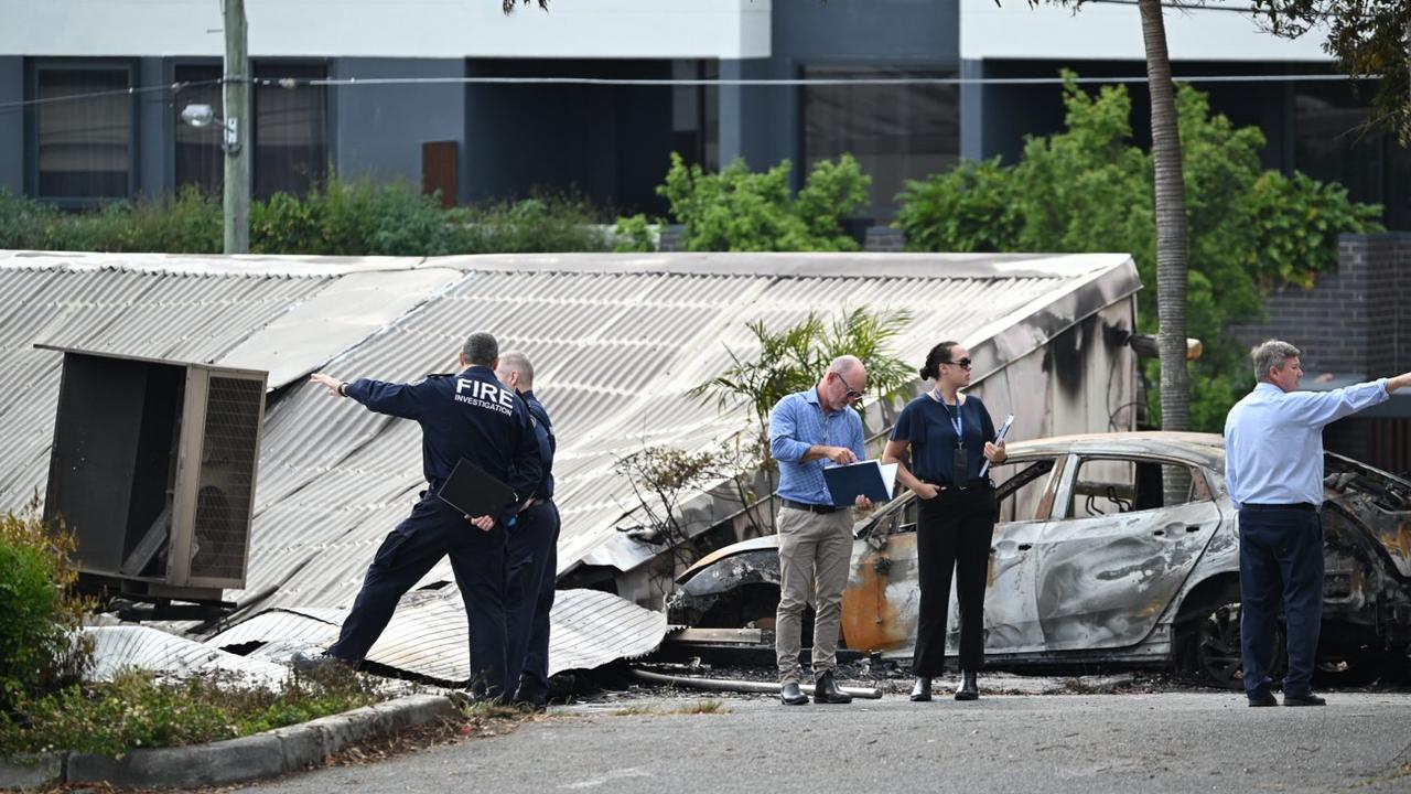 Police and fire investigators picture at the scene of a fire in Woolloongabba on Wednesday. Picture Lyndon Mechielsen