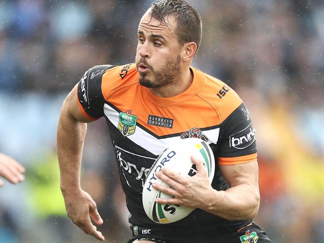 SYDNEY, AUSTRALIA - JUNE 10: Josh Reynolds of the Tigers runs the ball during the round 14 NRL match between the Cronulla Sharks and the Wests Tigers at Southern Cross Group Stadium on June 10, 2018 in Sydney, Australia. (Photo by Mark Kolbe/Getty Images)