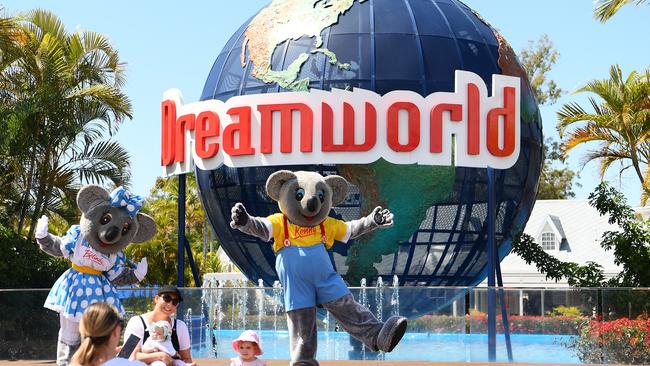 Patrons pose for a photo at the entrance of Dreamworld. (Photo by Quinn Rooney/Getty Images)