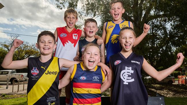 Footy fans Darcy White, 11, Griffin Firth, 7, Zach Kerber, 10, Harrison Firth, 11, Holly Harris, 10, and Bridie Loffler, 11 in Millswood. Thursday, Nov. 3, 2022. Picture: Matt Loxton