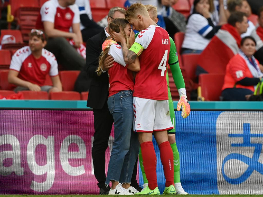 Sabrina Kvist Jensen is consoled by Simon Kjaer.