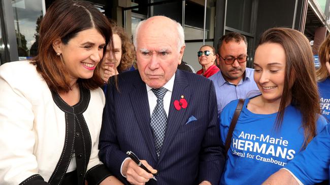 John Howard signs autographs as he joins the Liberal’s Victorian state election campaign yesterday. Donald Trump could learn much from his calm stewardship of the country. Picture: Stuart McEvoy/The Australian.