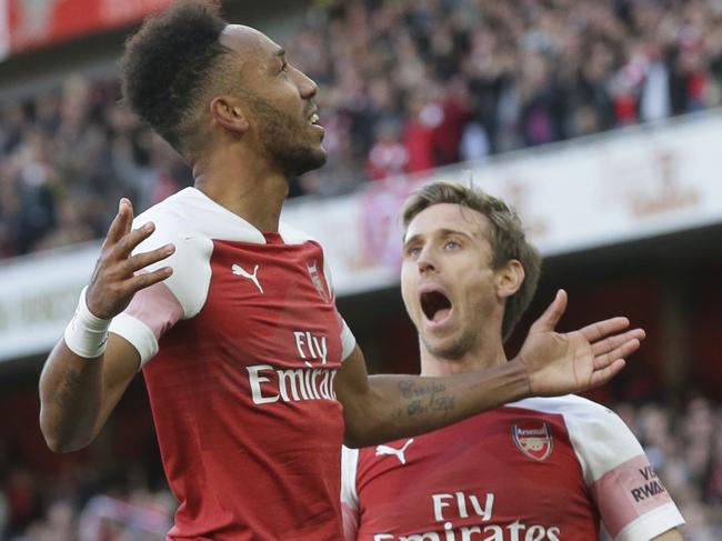 Arsenal's Pierre-Emerick Aubameyang, left celebrates with Arsenal's Nacho Monreal after scoring his side's 2nd goal during an English Premier League soccer match between Arsenal and Everton at the Emirates Stadium in London, Sunday Sept. 23, 2018. (AP Photo/Tim Ireland)