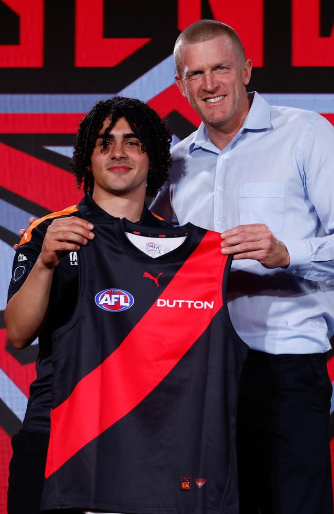 Kako was presented his Essendon jumper by Dustin Fletcher. Picture: Michael Willson/AFL Photos via Getty Images