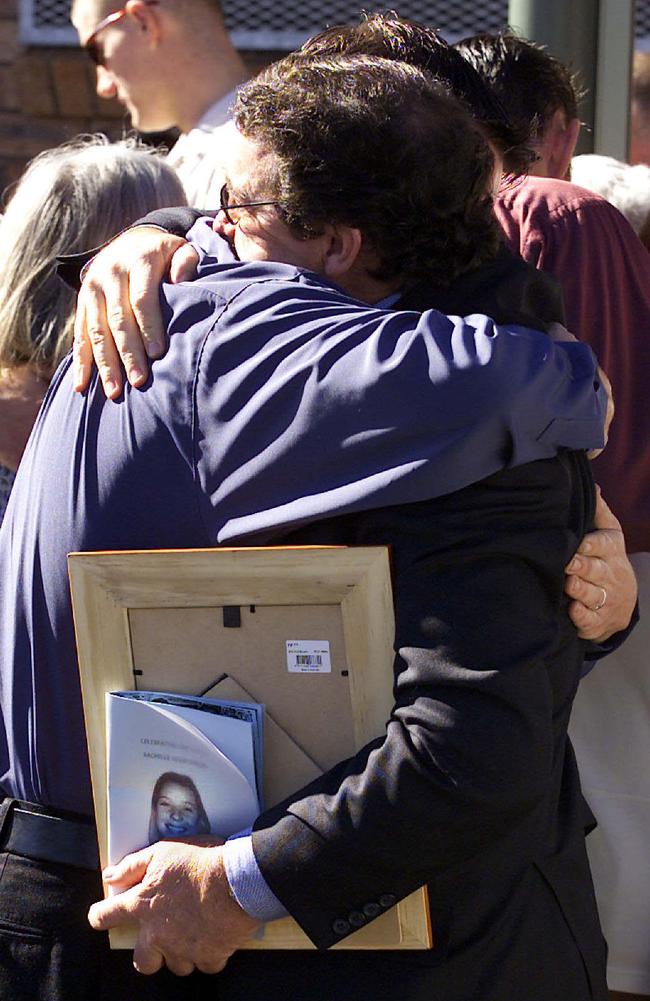 Graham Childs is comforted at the funeral of his daughter Rachelle Childs (23), whose burnt body was found at Gerroa in June 2001. Picture: Troy Bendeich