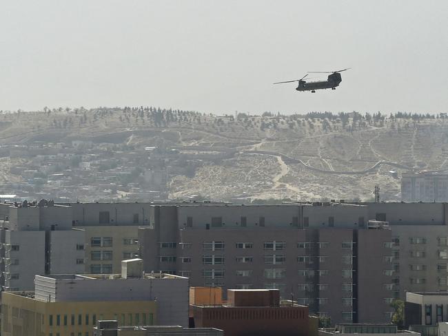 A US military helicopter is pictured flying above the US embassy in Kabul on Sunday. Picture: AFP