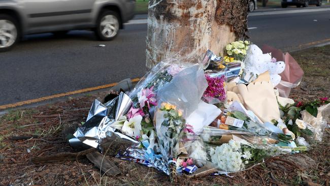 Flower tributes have been placed at the base of a tree on the corner of Culver Street and the Grand Parade in Monterey for the two children that died in a car crash. Picture: Damian Shaw.