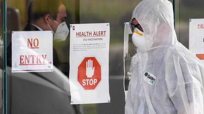 A medical worker enters the Epping Gardens aged care facility in Epping