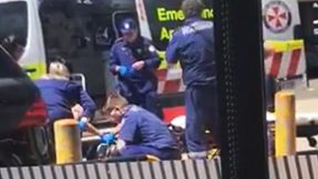 Paramedics work to save Mick Hawi after he was shot outside the Fitness First at Rockdale. Picture: Supplied