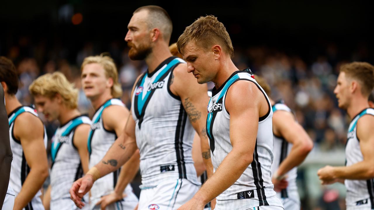 Port players trudge off after their heavy loss.