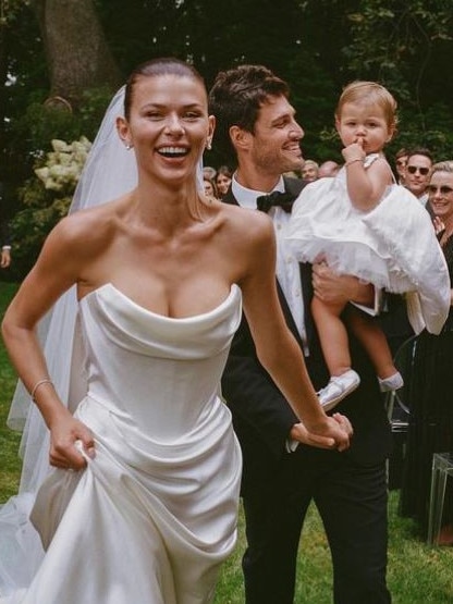 Fowler at her wedding to Nathan Dalah, holding their daughter, in 2023. Picture Rob Tennent